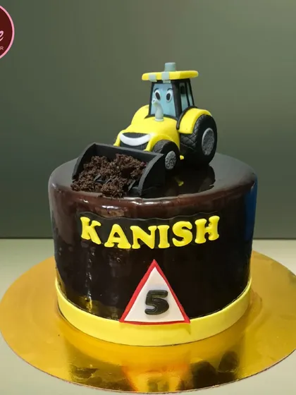 A fun and realistic JCB digger cake, perfect for a little construction fan. The cake is covered in rich chocolate ganache, and the digger is even scooping up "dirt" made from cookie crumbs.