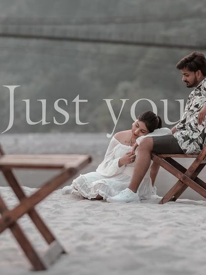 A tender moment of rest on the beach, with her head in his lap. The chairs used as framing elements add a creative touch to this intimate portrait.