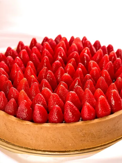 A tart worth a thousand words. This larger-than-life Chocolate Pudding Tart, covered in fresh strawberries, was the heart of a love story, made with passion and persistence.