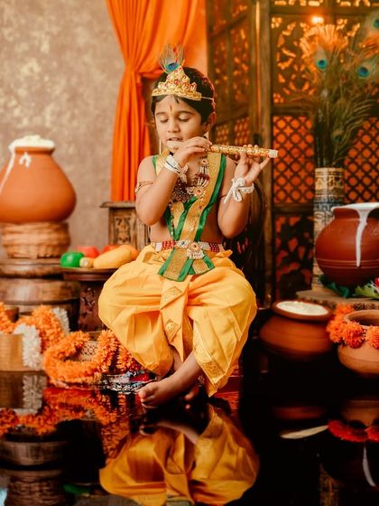An older child dressed as Krishna, playing the flute with a beautiful reflection, creating a powerful and artistic image.