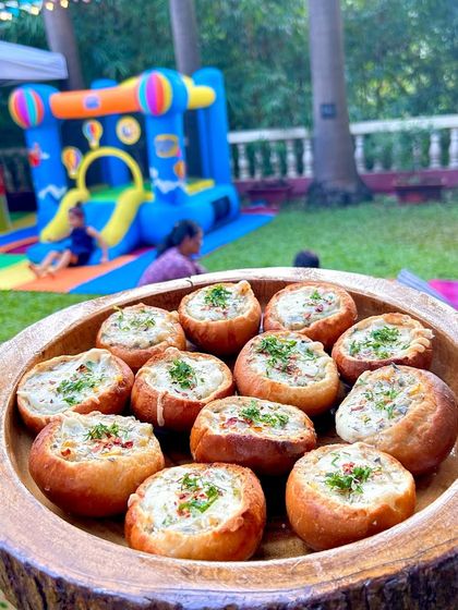 A close-up of my exotic veggie buns, filled with a creamy mixture and baked to perfection. They are a perfect warm appetizer for any outdoor event.
