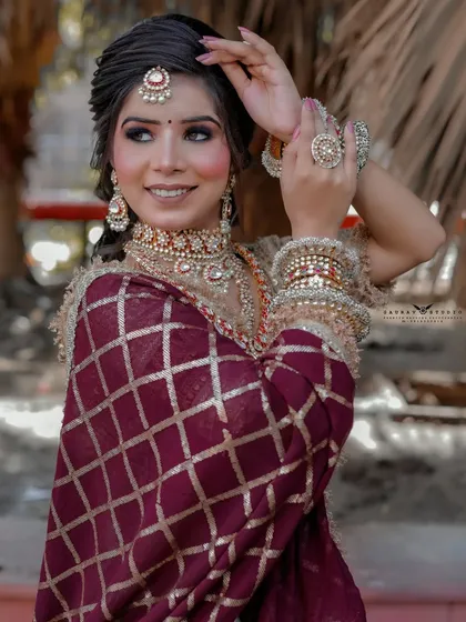 A lovely portrait capturing the bride's happy expression and the details of her jewelry.