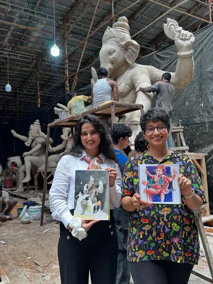 Me and a fellow artist proudly showing our work at the Ganpati idol workshop. The background shows the raw, beautiful chaos of the workspace, where these magnificent idols are born.