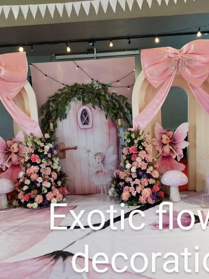 A whimsical photo booth for a fairy-themed party. We used large pink bows, floral arrangements, and fairy cutouts to create a dreamlike setting for photos.