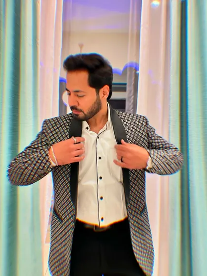 Adjusting my collar, a final check before I step into the spotlight. It's all about the details.