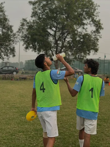 Teammates hydrating together during a break in training. Hard work requires proper recovery, and we make sure our players understand that.