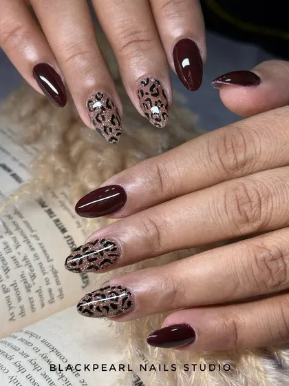 This design is for when you're feeling bold and elegant at the same time. I paired a rich, deep brown gel polish with hand-painted cheetah print accent nails, adding a layer of fine glitter to make the pattern pop.