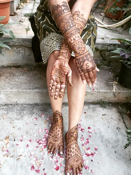 Another angle of the full bridal mehendi, showing how the designs on the arms and legs create a harmonious and stunning overall look.