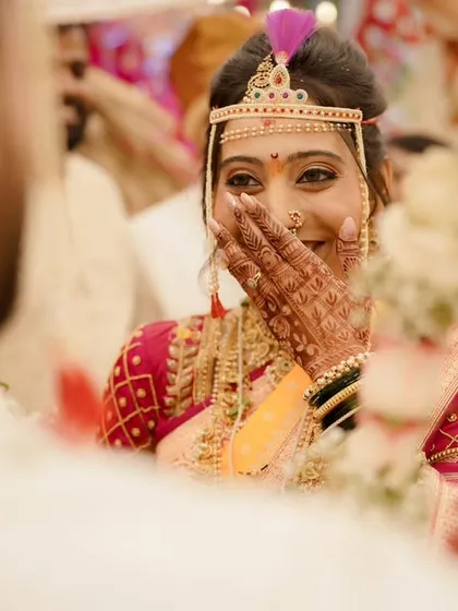 A shy smile and a happy glance. This candid shot shows how the makeup looks natural and beautiful, capturing the genuine emotions of the wedding day.