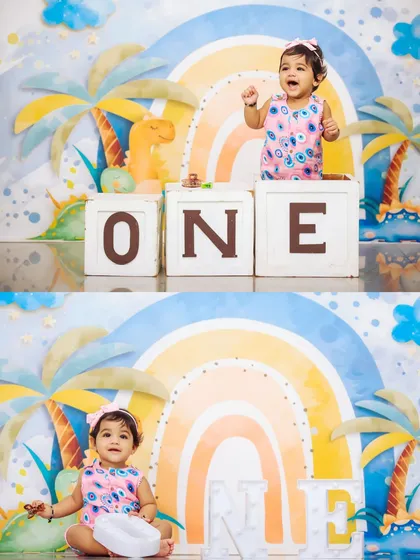 This first birthday setup features fun 'ONE' blocks and a cheerful dinosaur and rainbow backdrop. It’s a perfect, colorful setting for capturing your baby's big milestone.