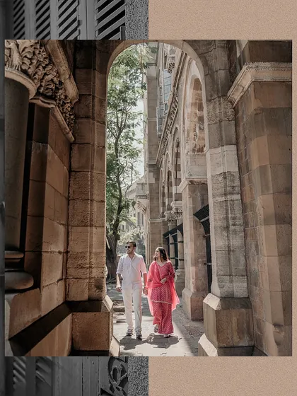 A lovely shot of the couple walking through the architectural corridors of Mumbai. The framing and her colorful outfit make this a visually striking pre-wedding photo.