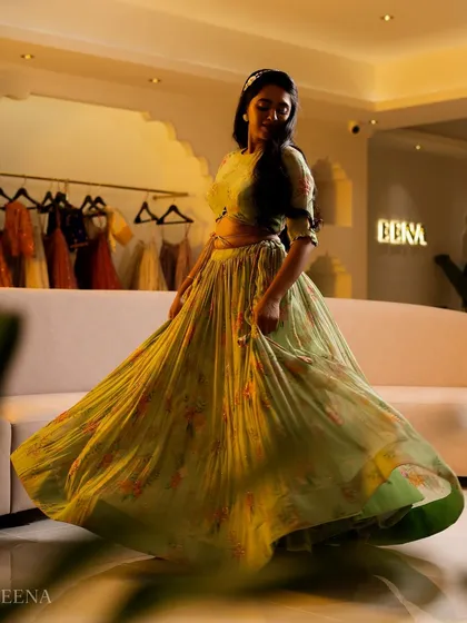 A dreamy, ethereal lehenga for the modern woman. This piece features a flowing, pleated skirt with a soft floral print, paired with a matching full-sleeve blouse for a look of effortless elegance.
