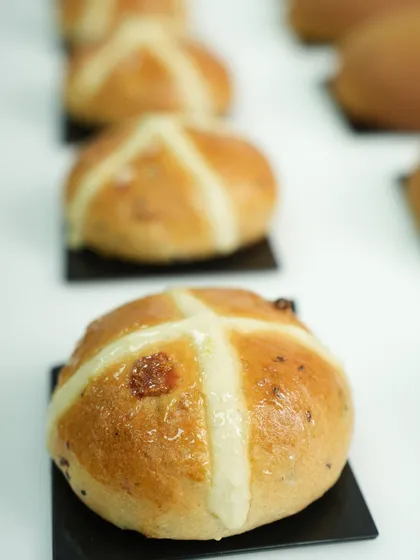 A close up of our perfectly baked hot cross buns. These are a type of enriched sweet bread, and I teach you how to get the signature cross and the soft, spiced dough just right.