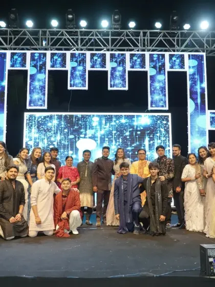 A group photo with the entire family and celebrity guest Dilip Joshi on the grand Sangeet stage.