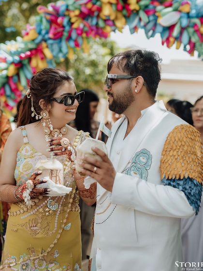 The couple, Harshit and Kritika, enjoying coconut water at their vibrant Mehendi/pool party.