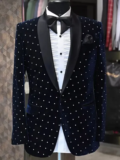 Another angle of the navy blue polka-dotted velvet tuxedo. It shows how the fabric catches the light, making it a perfect choice for evening events.