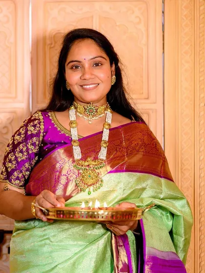 Holding a traditional plate of diyas, this client's festive makeup glows. The look is perfect for celebrating Diwali, with an emphasis on radiant skin and beautifully defined features.