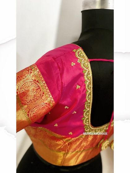 A side view of the pink blouse with a golden brocade sleeve and delicate beadwork along the neckline.