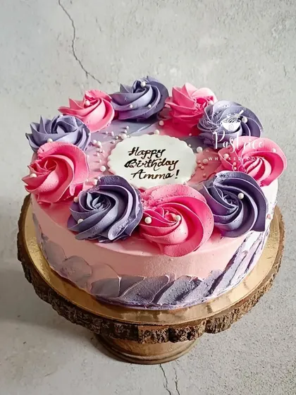 A cake for Amma, made with all my love. This beautiful strawberry cake is decorated with delicate pink and purple buttercream roses, showing that a cake can be as beautiful as it is delicious.