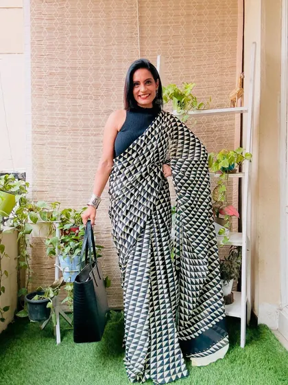 A striking black and white saree with a geometric triangle print. This is a very modern and bold saree, perfect for an art event or a stylish evening out.