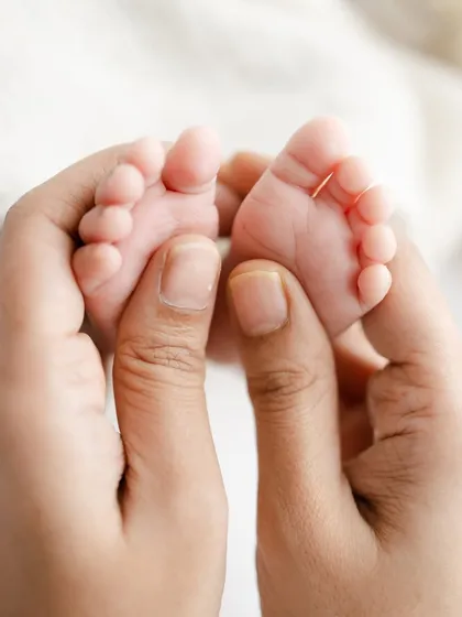 A macro shot capturing the tiny, perfect details of a newborn's feet. These detail shots are a beautiful way to remember just how small they once were.