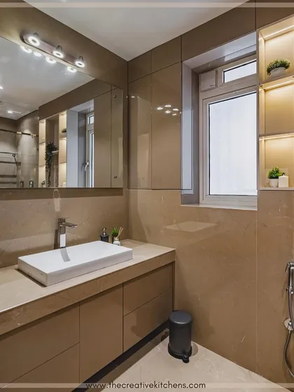 We focus on sensible planning to meet everyday storage needs. This bathroom vanity provides ample drawer space and is paired with a mirrored cabinet and illuminated window-side shelving to maximize the use of space.