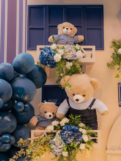 Teddy bears peek out from window boxes filled with blue and white hydrangeas. It's these small, charming details that bring a theme to life.