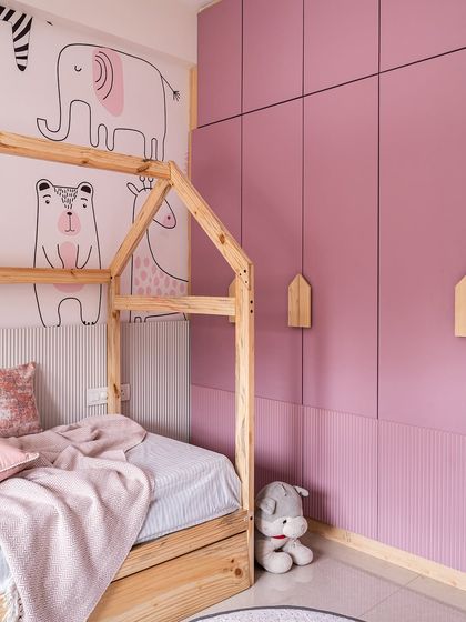 A duplicate of image 290, showing the playful pink bedroom with a house-frame bed and animal wallpaper.