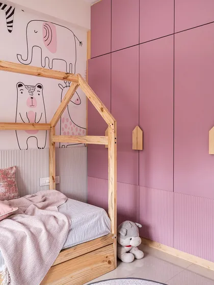 A duplicate of image 290, showing the playful pink bedroom with a house-frame bed and animal wallpaper.