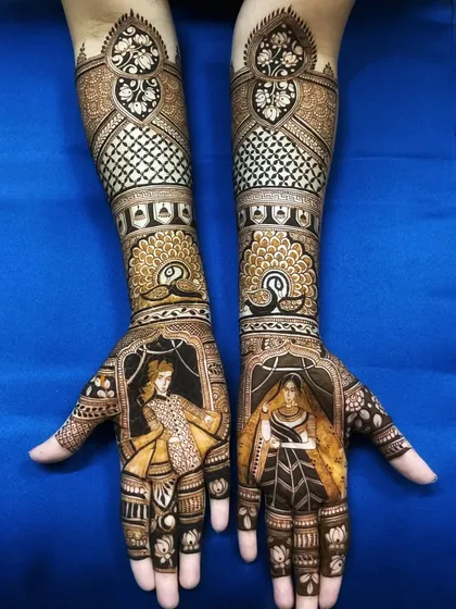 A clear view of a full-arm bridal design with bride and groom portraits. The dark, bold lines make the figures stand out, while the upper arms feature traditional net and floral patterns.