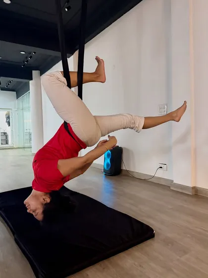 A moment of pure serenity in a supported inversion. This pose allows the spine to lengthen naturally, relieving pressure and creating a sense of calm.