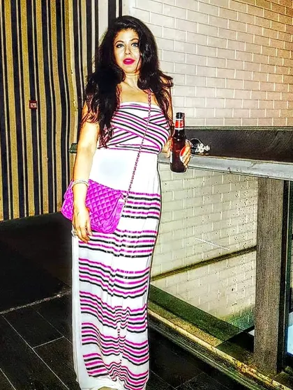 This striped tube gown is a perfect example of custom tailoring. It's designed to be slimming and is made from a comfortable, crease-proof fabric, making it ideal for travel or an evening out.
