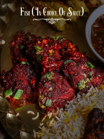 Our flavorful fish starter, served in your choice of sauce, as part of the Dostana Thaal. Here it is shown tossed in a spicy, tangy sauce over a bed of biryani rice.