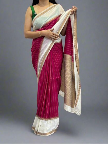 A model wearing the rani pink and white semi-wrinkle crepe saree, paired with a contrast green blouse.