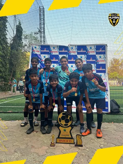 The U13 champions with their trophy. Their performance in the tournament was a masterclass in teamwork and skill.