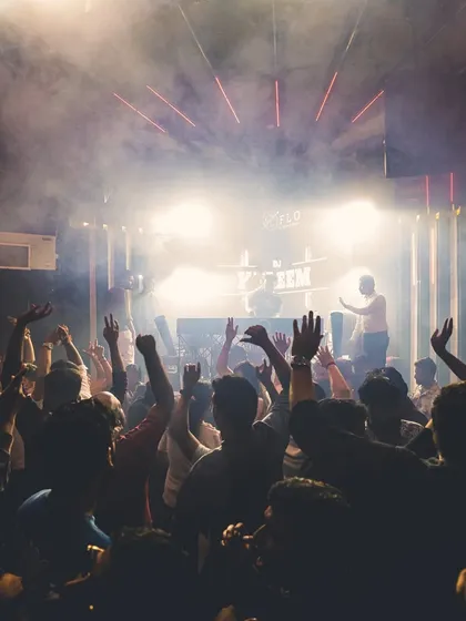 A sea of hands in the air at one of my club nights. My goal is simple: get everyone moving and vibing together on the dance floor.