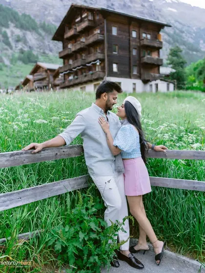 A moment of connection in the Swiss meadows. The classic wooden chalet in the background adds to the storybook feel of their pre-wedding shoot in Zermatt.