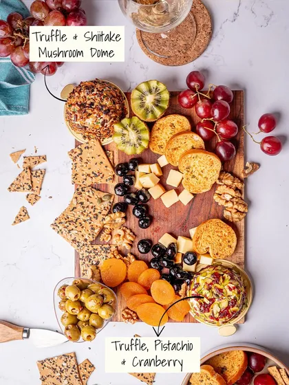 A glimpse of our signature cheese platters, where it all began. This board features two of our handcrafted truffle cheese domes, the Truffle & Shiitake Mushroom and the Truffle, Pistachio & Cranberry, paired with artisanal crackers, fresh fruits, and nuts for a perfect gourmet experience.