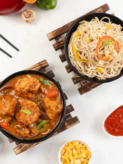 A perfect pairing of noodles and manchurian. Combination shots like this are great for promoting meal combos and special offers on a restaurant's menu.