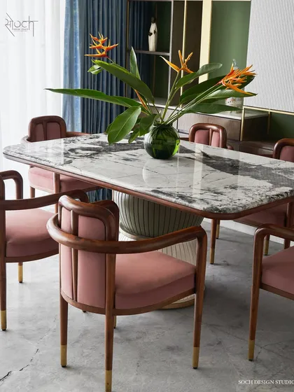 Meet the “Pellet Drum” dining table, a piece inspired by the form of Shiva’s damru. Its base features grooved spheres finished in dual-tone polyurethane, supporting a magnificent Patagonia marble top. Paired with our bent teakwood 'Svelte' chairs, this set makes every meal a statement.