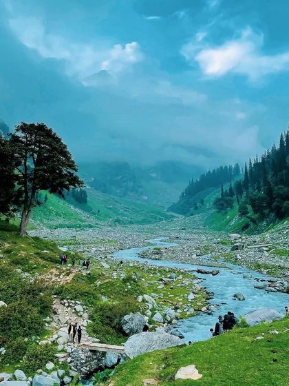The beautiful river valley on the Hampta Pass trail, with its lush green meadows and meandering river.