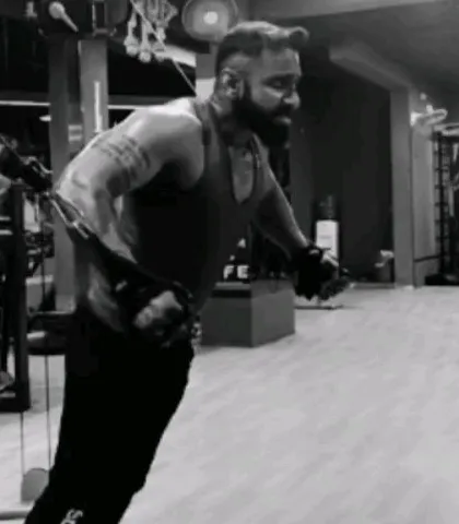 Performing a cable crossover to sculpt the chest. This exercise helps in creating definition and striations, showing my technical approach to bodybuilding.