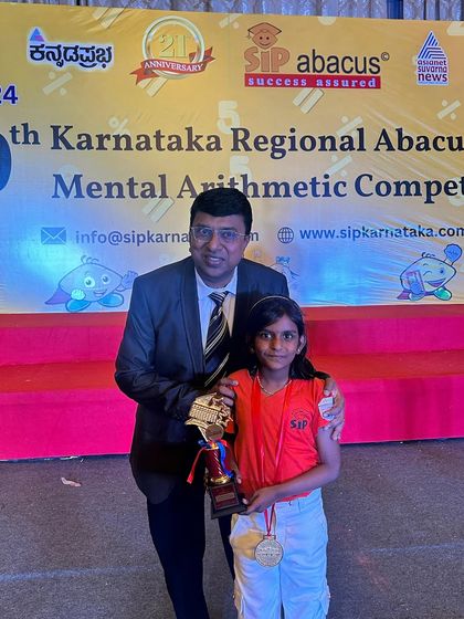 A proud moment as one of our students receives her trophy and medal at the state-level competition. Her hard work and dedication have truly paid off.
