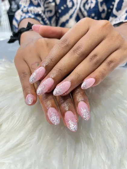 You can never go wrong with a bit of sparkle. For this look, I used acrylic extensions to create an elegant almond shape and then applied a beautiful falling glitter effect with silver sparkles over a soft pink gel base. It’s glamorous, yet so classy.