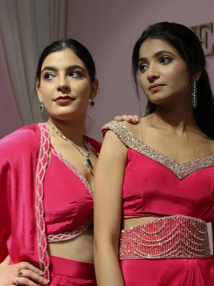 A close-up of two of our pink outfits from the 'DESIRE' collection, showing the delicate hand-embroidered borders.