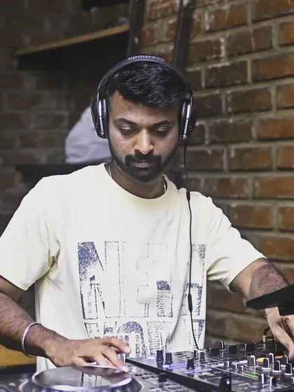 Another view of me working the decks, showing my hands-on approach to mixing.