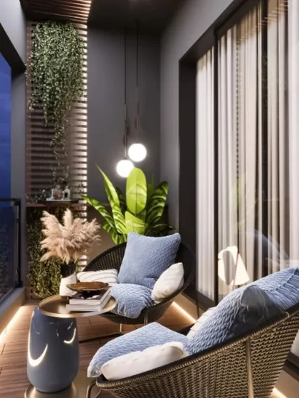 This image captures a modern balcony at dusk, highlighting the importance of ambient lighting. Floor-level strip lighting and soft pendant lights create a warm, inviting glow on the wicker chairs and wooden deck, perfect for a quiet evening outdoors.