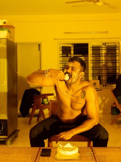 'Birthday cake', a self-portrait by Sandeep TK from his solo show. The image is both playful and introspective, capturing a moment of private ritual.