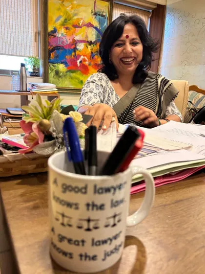 A candid moment in my office. The mug says, "A good lawyer knows the law. A great lawyer knows the judge." For me, being a great lawyer means understanding the human element of justice, not just the letter of the law. It is about fighting for what is right with passion and integrity.