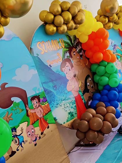 A close-up of a Chhota Bheem-themed backdrop, showing the colorful characters and balloon details.